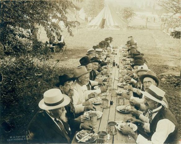 Veterans break bread together in this iconic 1913 photo taken by Reunion photographer W.H. Tipton. Photo Courtesy: Adams County Historical Society.